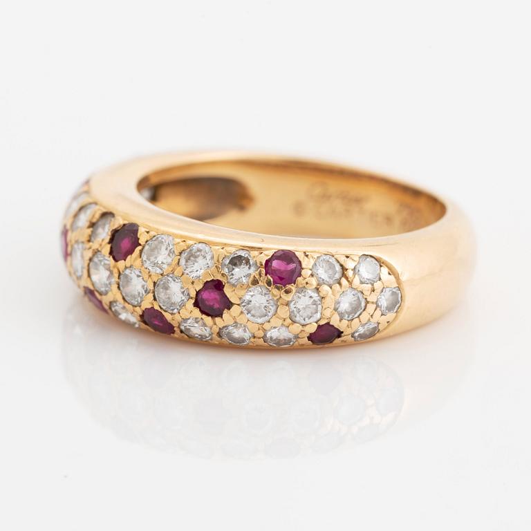 An 18K gold Cartier ring set with round brilliant-cut diamonds and rubies.