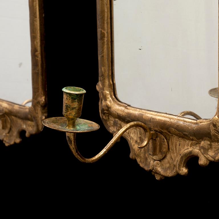 A pair of Swedish Rococo one-light girandole mirrors.