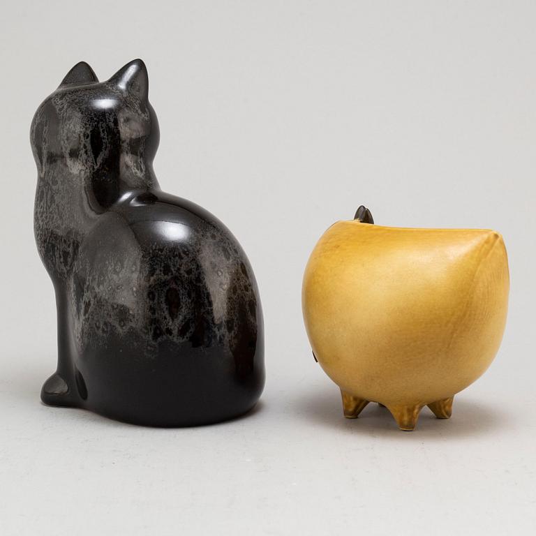 LISA LARSON, two stoneware figurines and a pair of candle holders, from Gustavsberg.