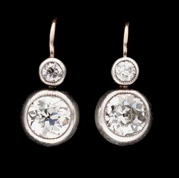 653. A pair of silver, gold and diamond earrings.