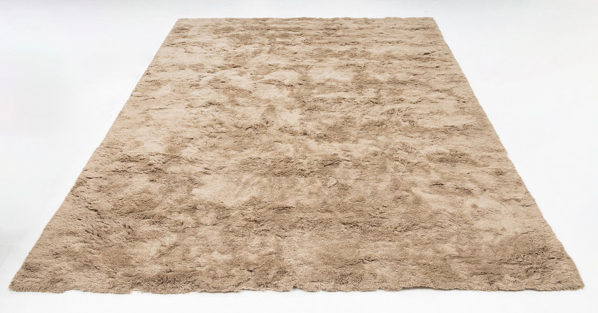 A monochrome carpet, 'Fallingwater - Mocha' by Layered, ca 400 x 300 cm.