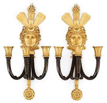 601. A pair of French Empire three-light wall-lights.