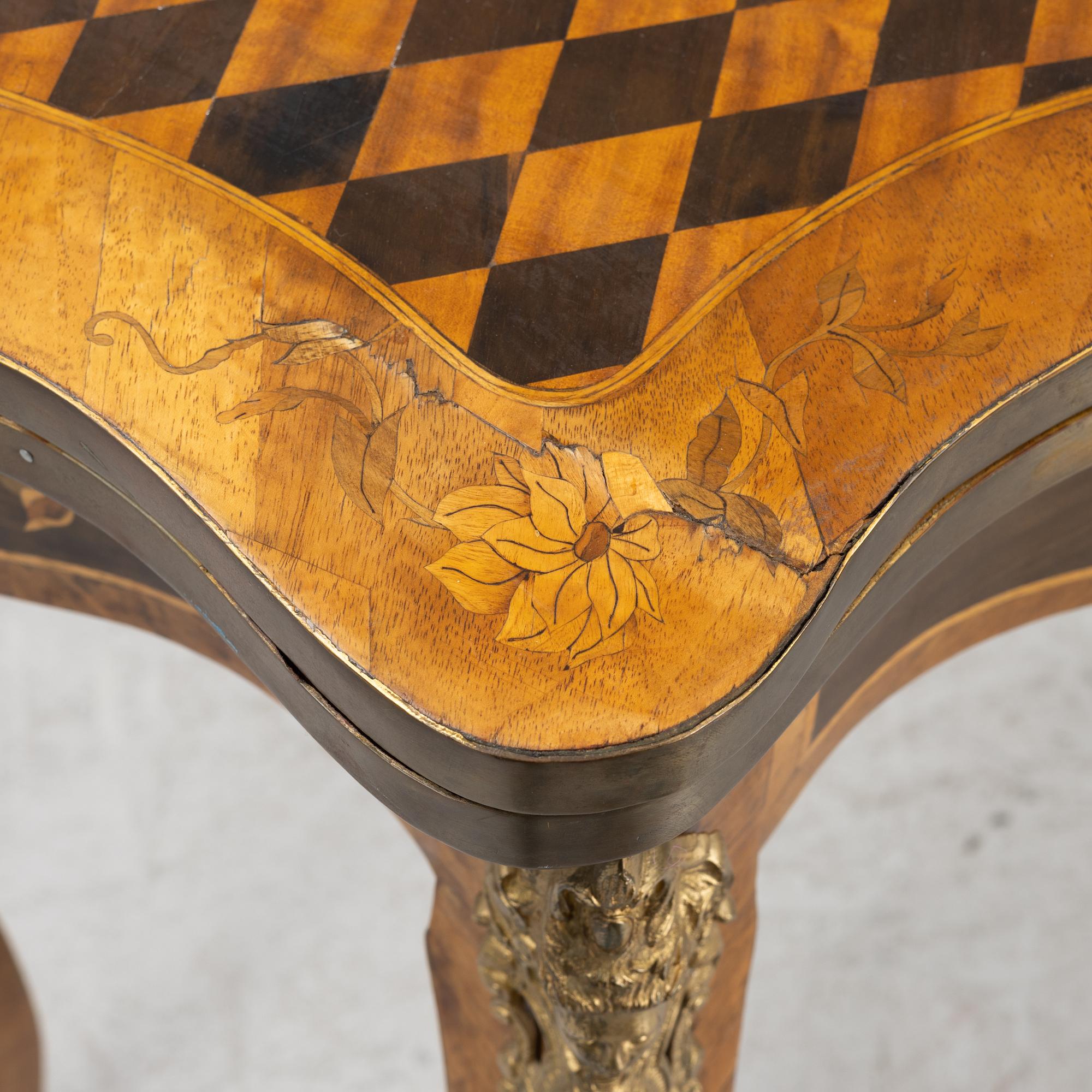 A Louis XV-style games table, early 20th century.