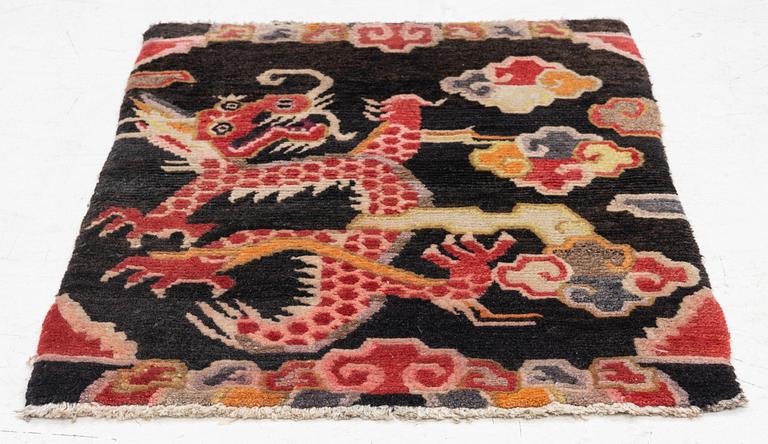 An semi-antique Tibet rug, 79 x 56 cm.