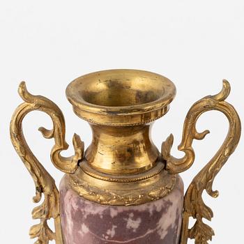 A Louis XVI-style Mantle Clock and a pair of decorative urns, early 20th Century.