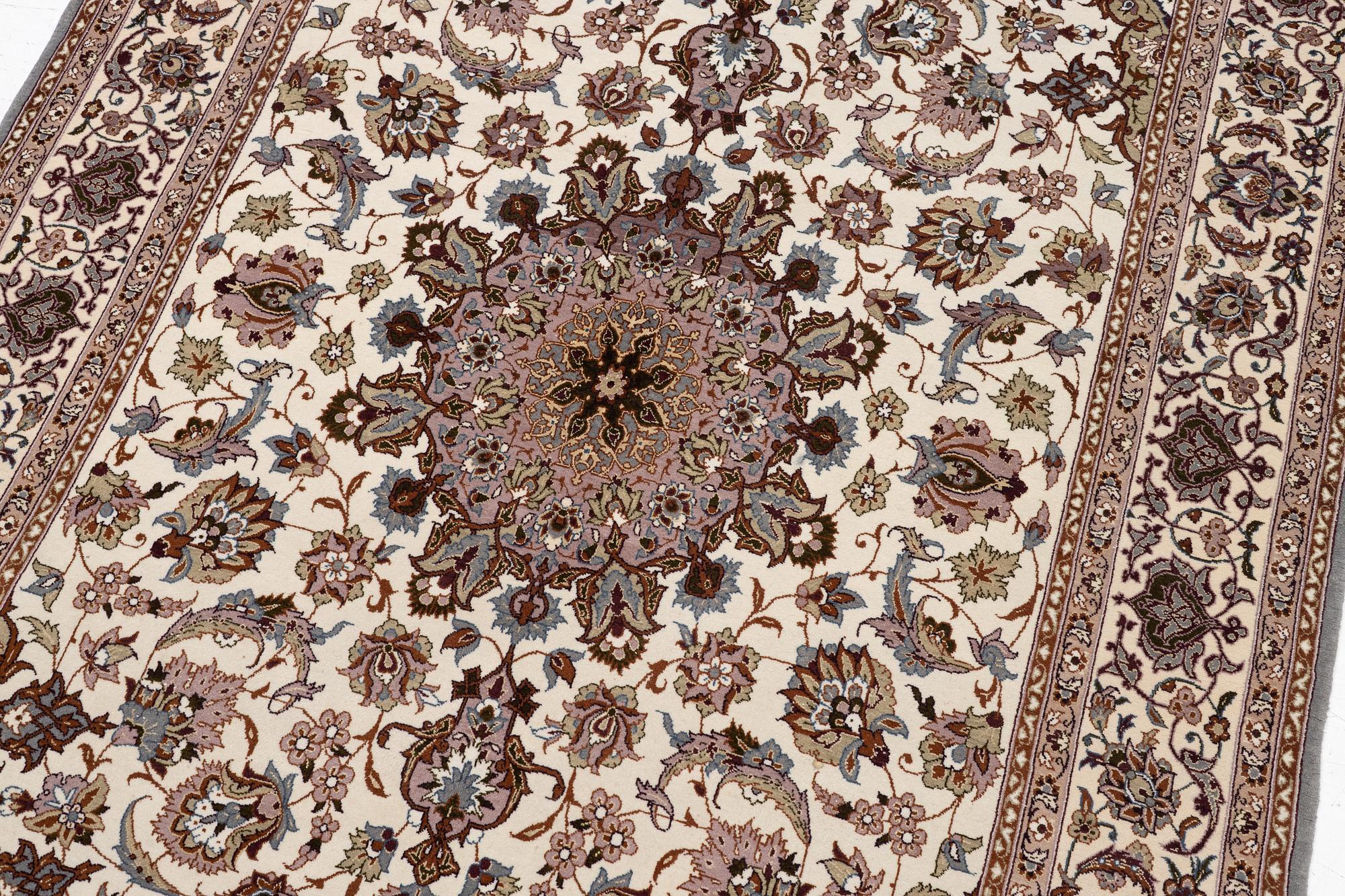 A semi-antique Isfahan rug, central Persia, signed Ghaffarian, c. 180 x 112 cm.