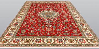 A signed Tabriz carpet, ca 336 x 223 cm.