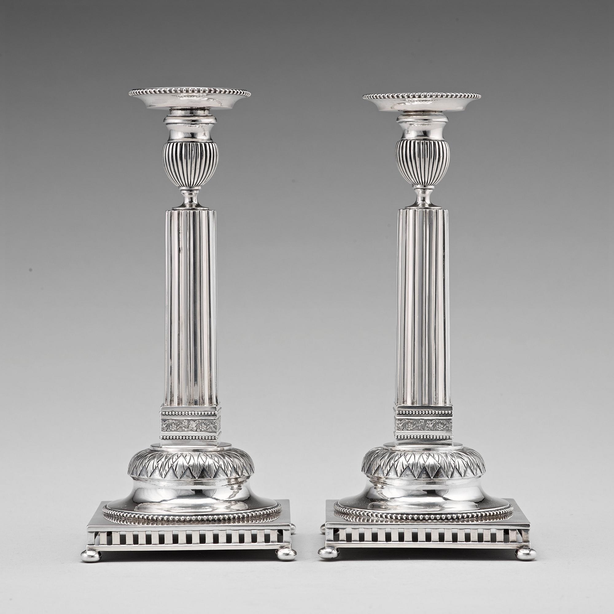 A pair of Swedish 18th century silver candlesticks, Stephan Westerstråhle, Stockholm 1793, one nozzle J E Torsk 1895.