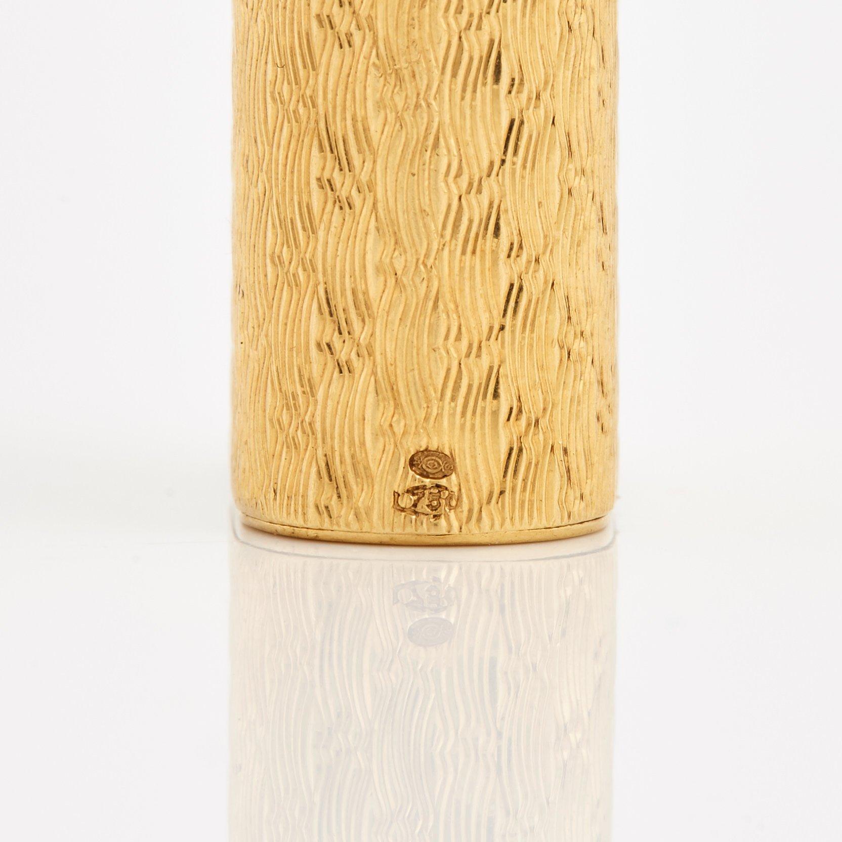 A cigarette lighter by Cartier set with single cut diamonds.