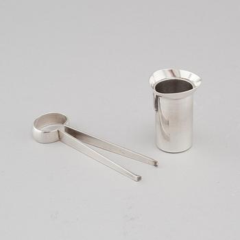 Two silver drink accessories with finnish stamps.