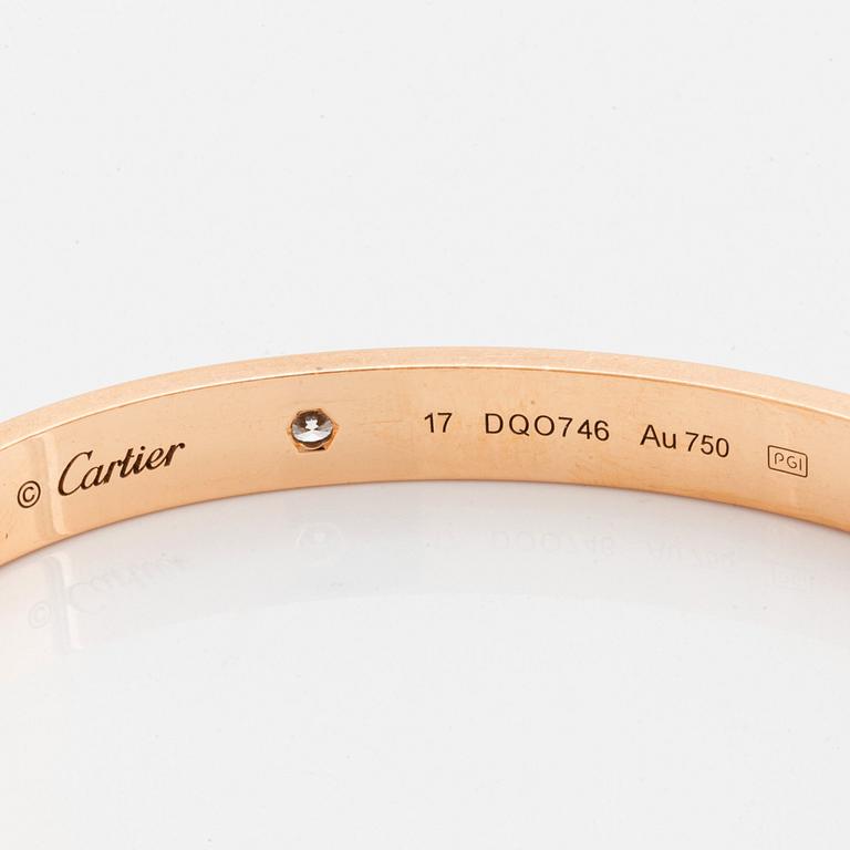 A Cartier "Love" bracelet in 18k rose gold set with four round brilliant-cut diamonds.