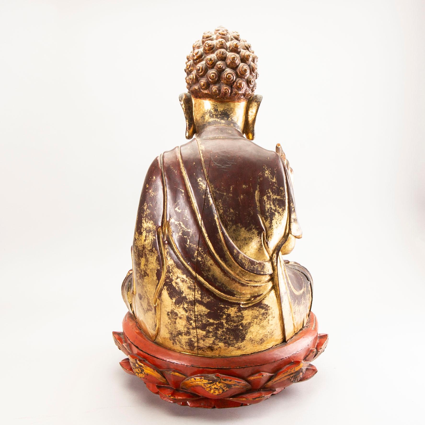 A large gilt and lacquered figure of a seated buddha, Qing dynasty, 19th Century.