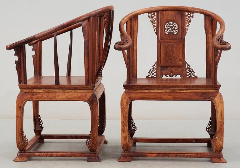 A pair of hardwood horseshoeback armchairs, late Qing dynasty, circa 1900.