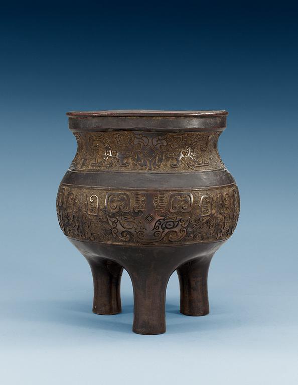 A large archaistic bronze tripod censer, probably Ming dynasty (1368-1644).