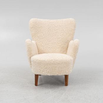 A lounge chair with new sheepskin upholstery, Sweden, second part of the 20th Century.