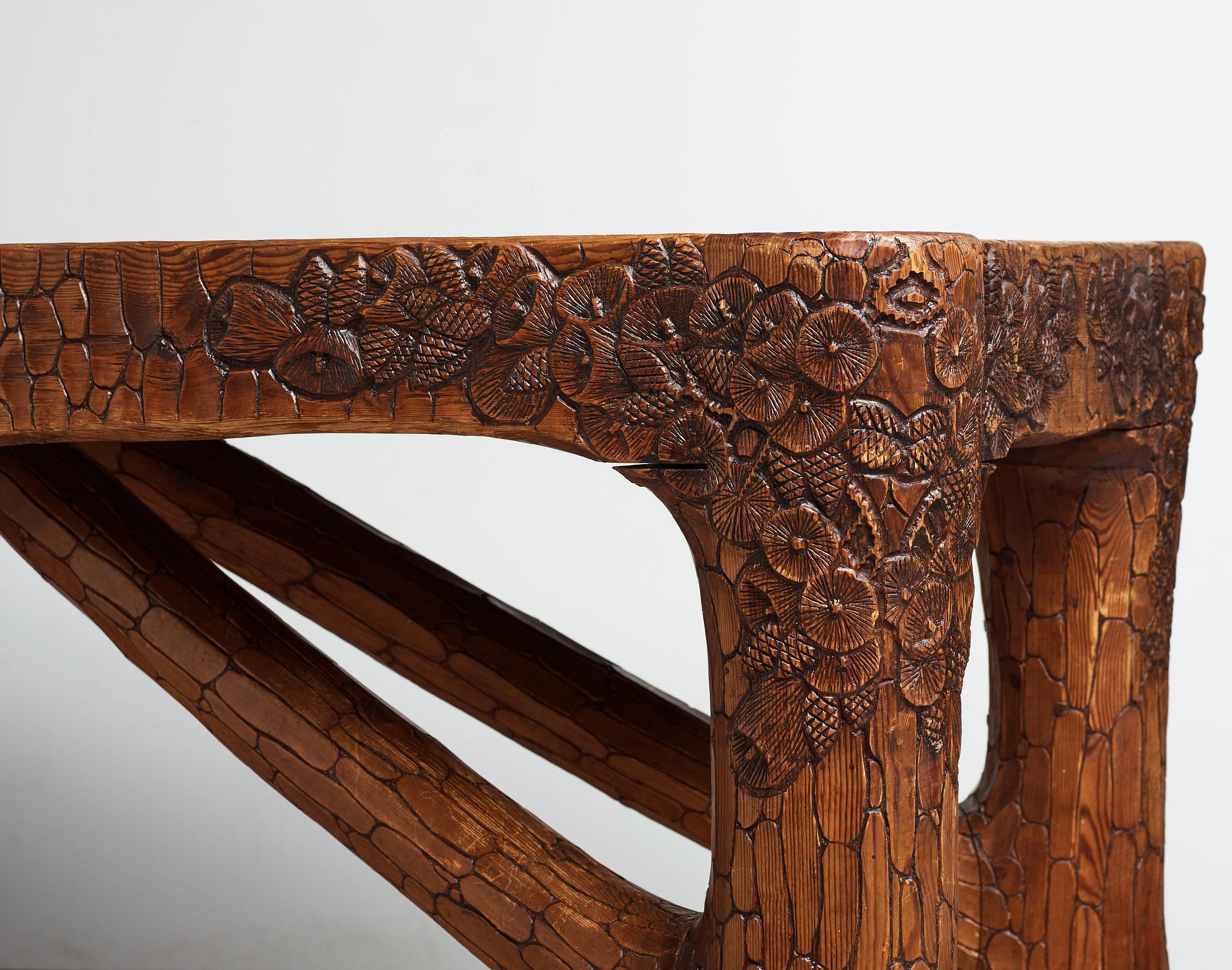 Gustaf Fjaestad, an Art Nouveau carved pine table, Arvika Sweden 1914, a double to the table in the Thiel Collection,