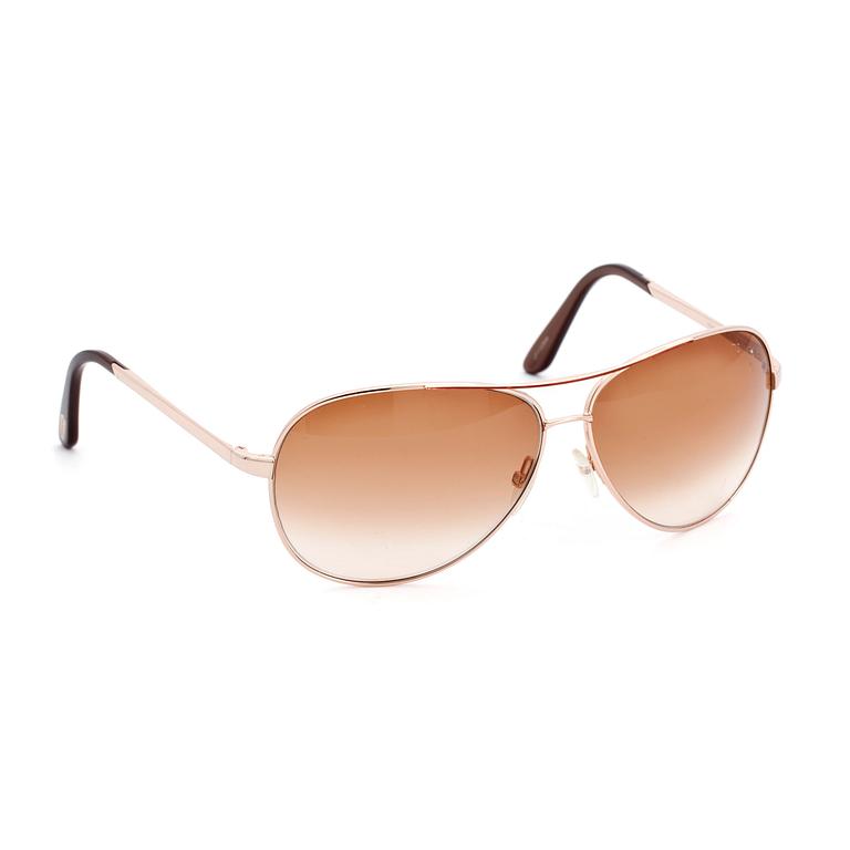TOM FORD, a pair of gold colored sunglasses.
