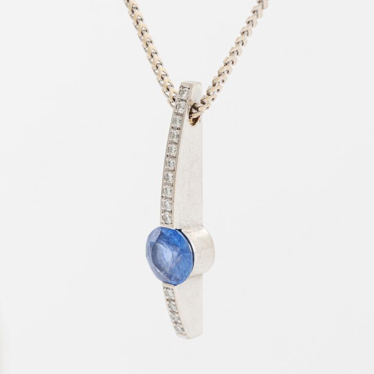 An 18K white gold necklace with a faceted sapphire.