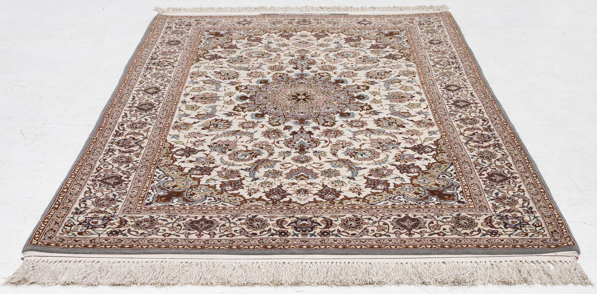 A semi-antique Isfahan rug, central Persia, signed Ghaffarian, c. 180 x 112 cm.