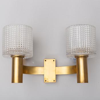 A pair of the 20th century brass and glass wall lights.