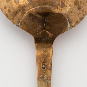 A brass basting spoon, circa 1800.