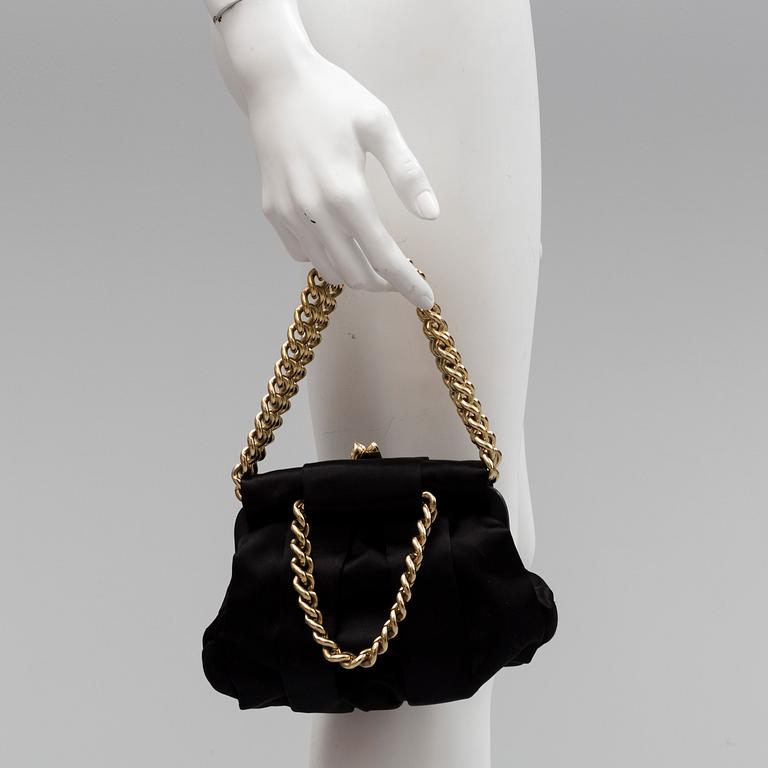 A black silk handbag by Christian Louboutin.