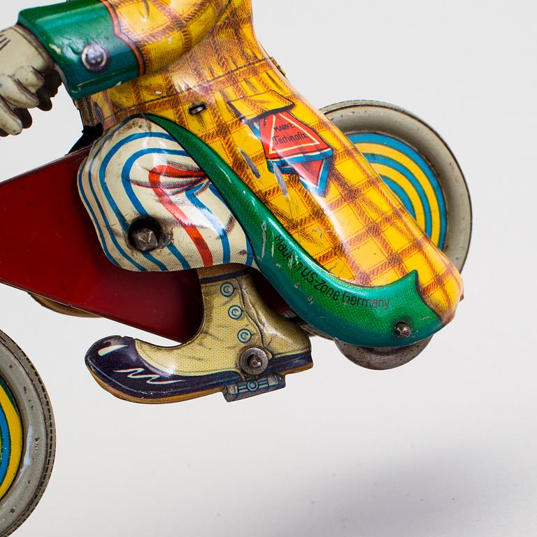 A tinplate Technofix bicycling clown Germany c. 1950.