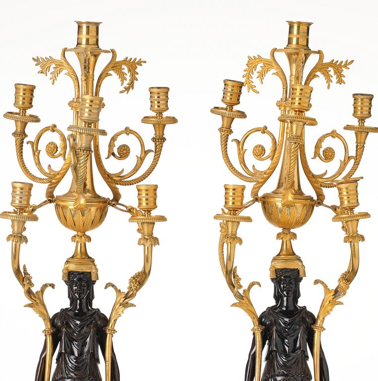 A pair of Louis XVI ormolu and patinated bronze six-branch candelabra attributed to François Rémond, late 18th century.