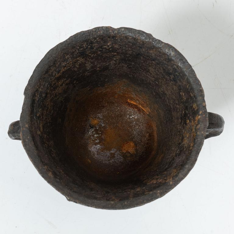 A cast-iron mortar and pestle of renaissance-type, 17th century.