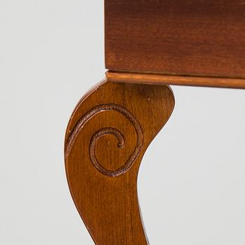 a pair of mahogany and marble tables from the late 20th century.