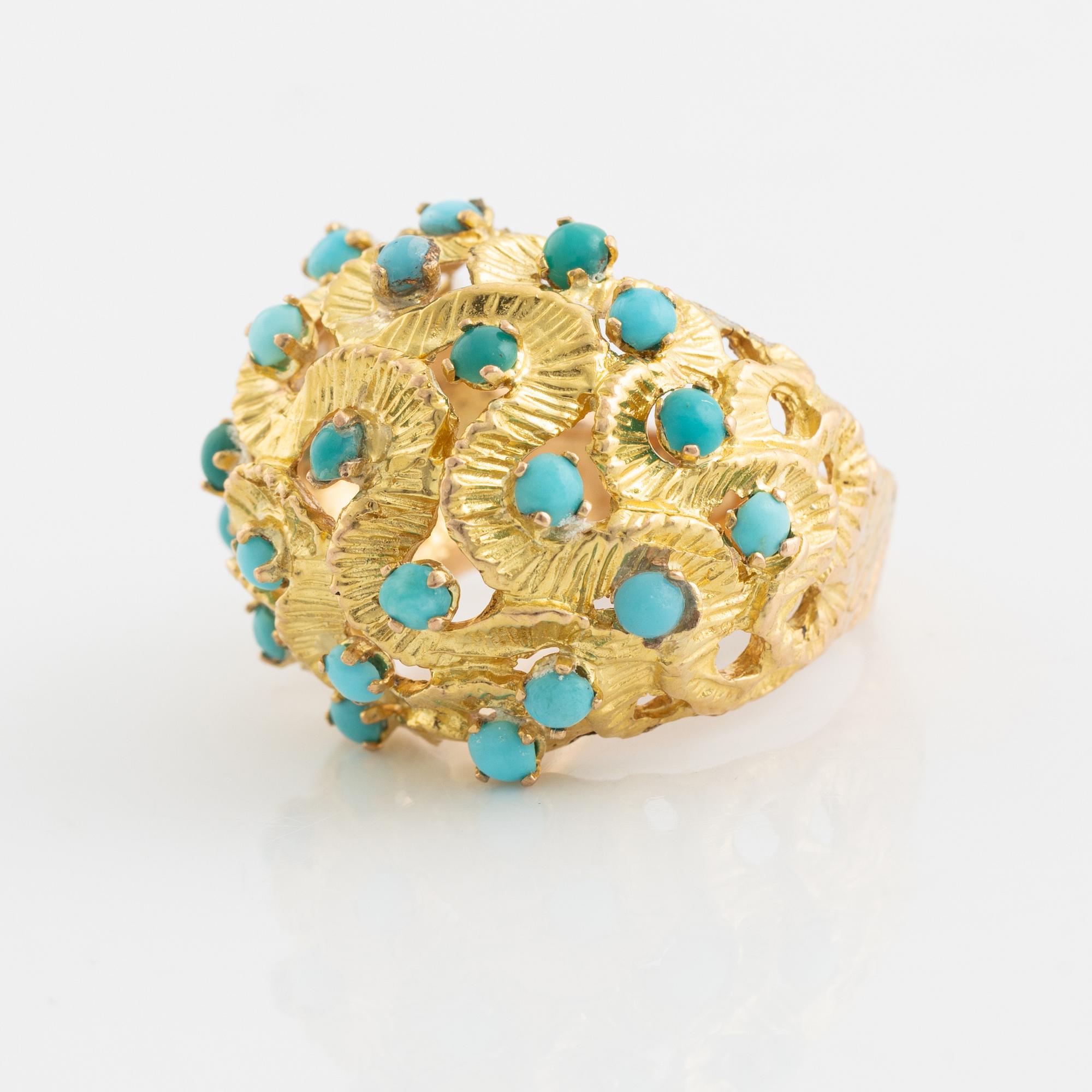 A 14K gold ring set with turquoises.