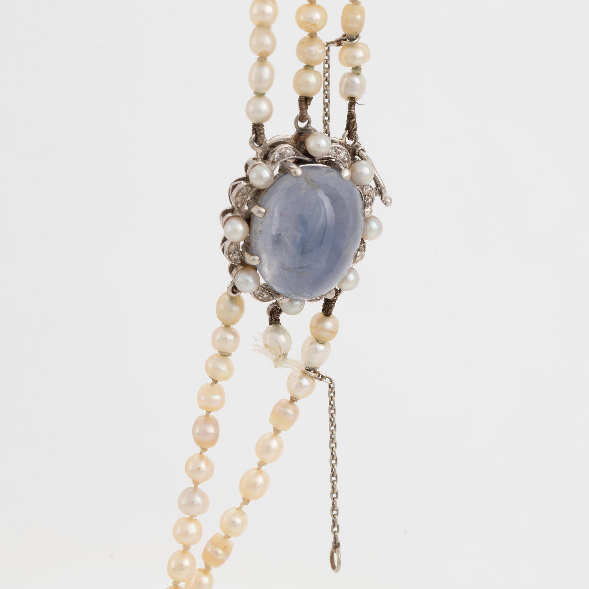 Three strand pearl necklace, clasp with cabochon cut sapphire.