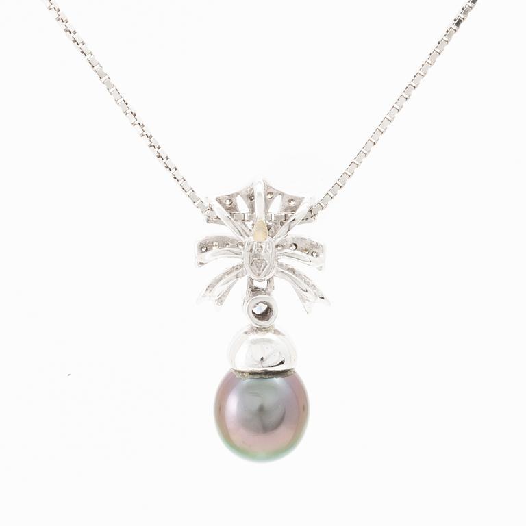 An 18K white gold necklace set with a drop-shaped cultured pearl and round brilliant-cut diamonds.