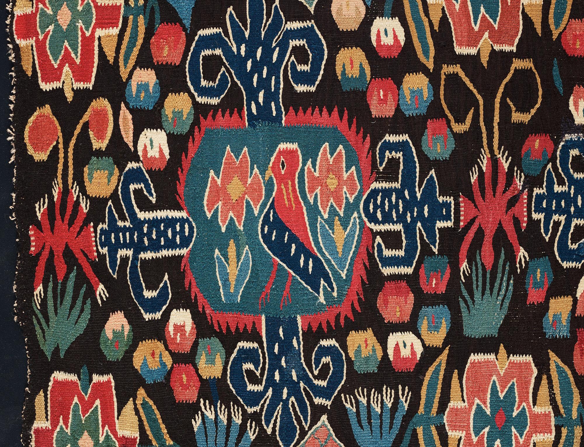 A CARRIAGE CUSHION FRAGMENT, tapestry weave, "Den innelykta fågeln", ca 52 x 67 cm, Scania (Sweden).