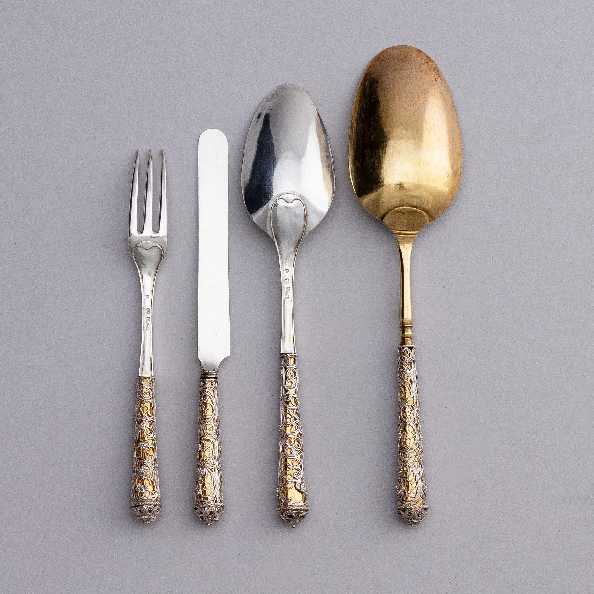 A Swedish parcel-gilt silver and filigree four-piece travel cutlery set, marks of Gustaf Otto Sjöberg, Falun 1813.
