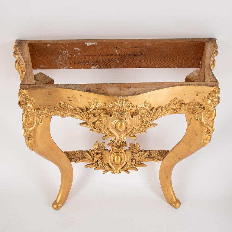 A mirror and console table from around the year 1900.