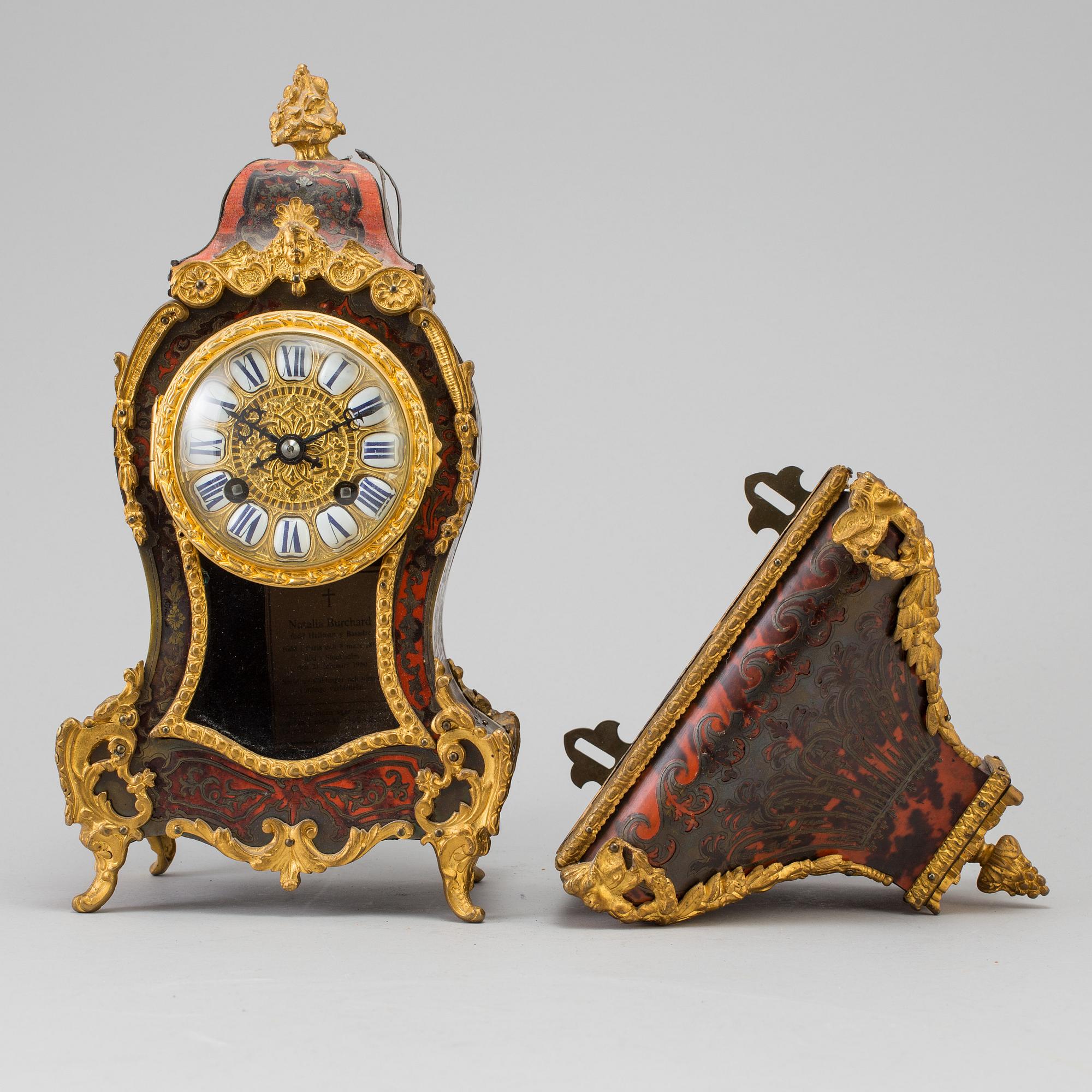 A Louis XV-style mantle clock with console base.