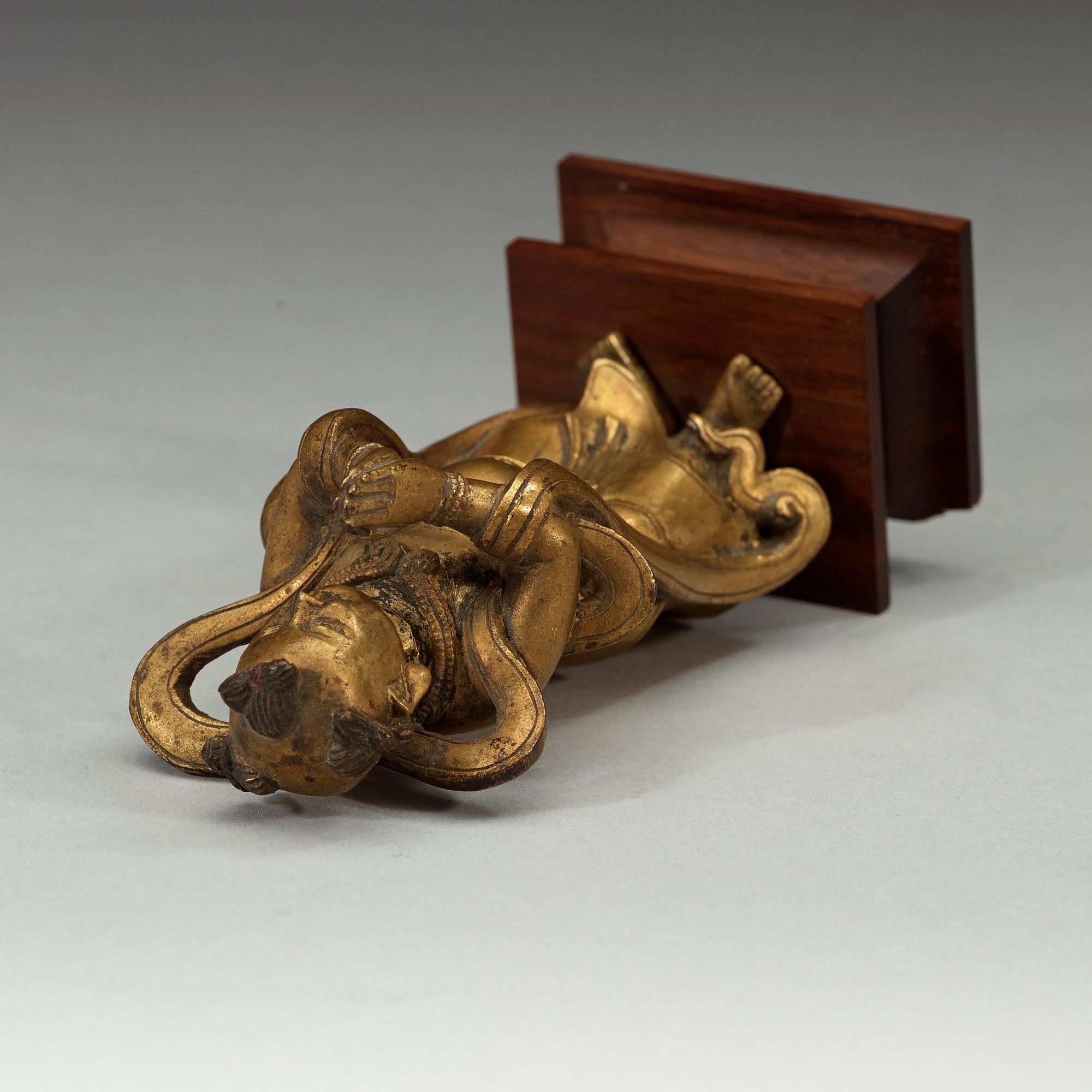 A gilt bronze figurine of a standing boy, Ming dynasty, 17th century.