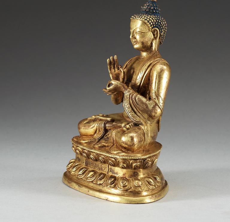 A gilt copper Buddha, presumably Qing dynasty, with Qian Long seven character mark.