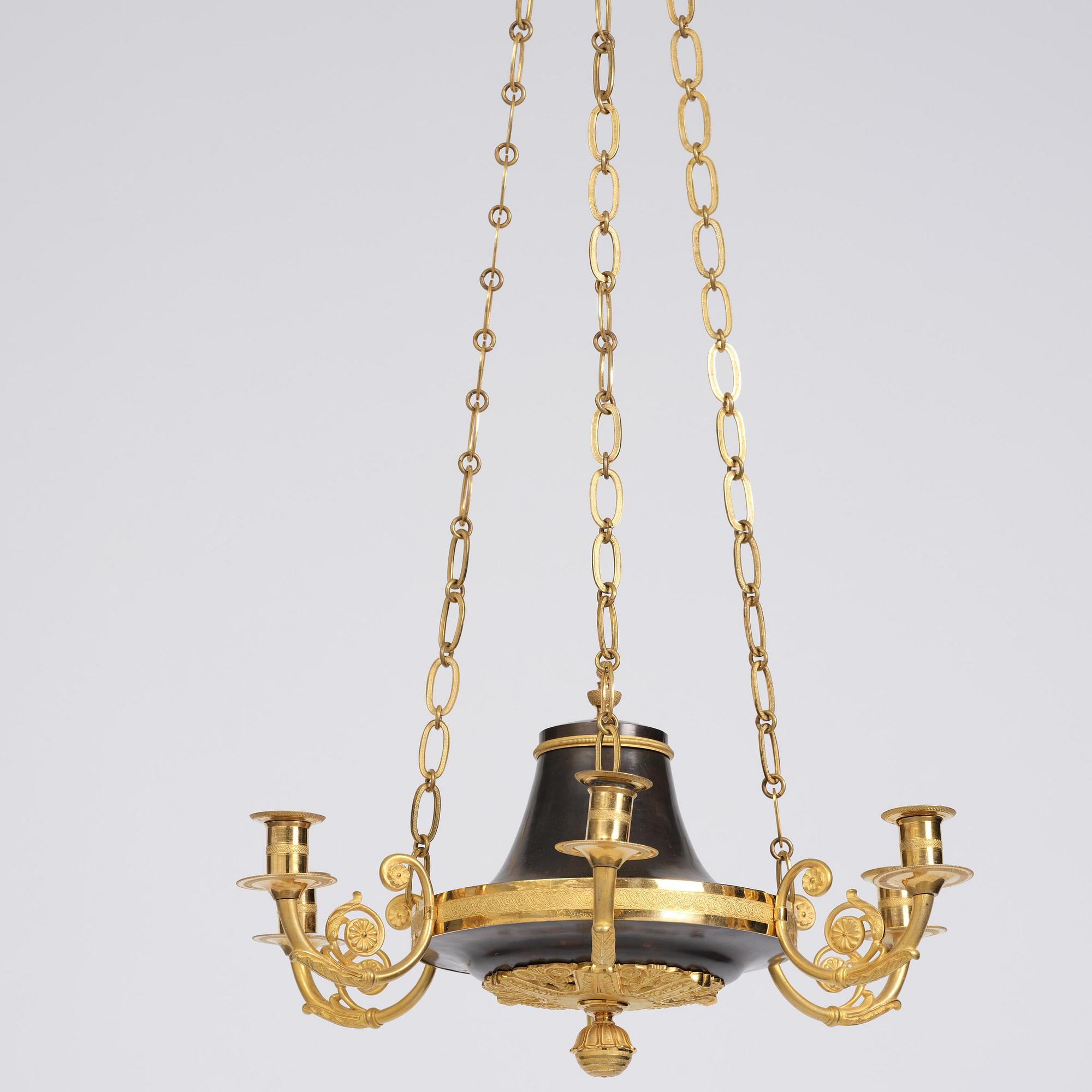 A Swedish Empire ormolu and patinated six-branch chandelier, Stockholm, early 19th century.