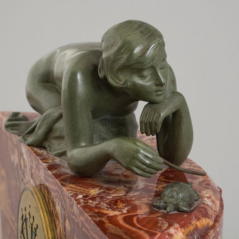 An early 20th century mantle clock with a bronze sculpture signed M. Charny.