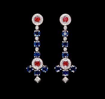 1009. A pair of blue sapphires- rubies and diamond ear pendants.
