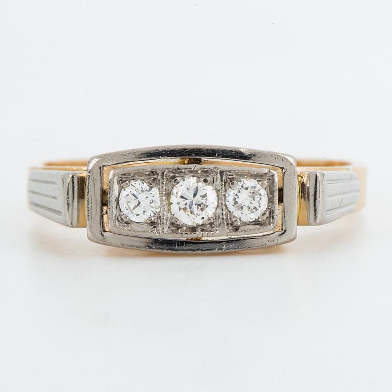 18K gold and brilliant-cut diamond three-stone ring.