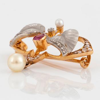 An 18K gold and platinum brooch set with pearls, rose-cut diamonds and a ruby.