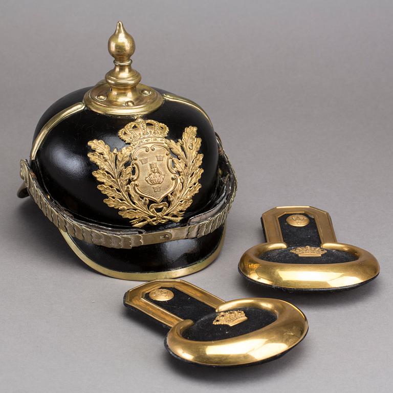 POLICE HELMET AND EPAULETTES AROUND 1900.