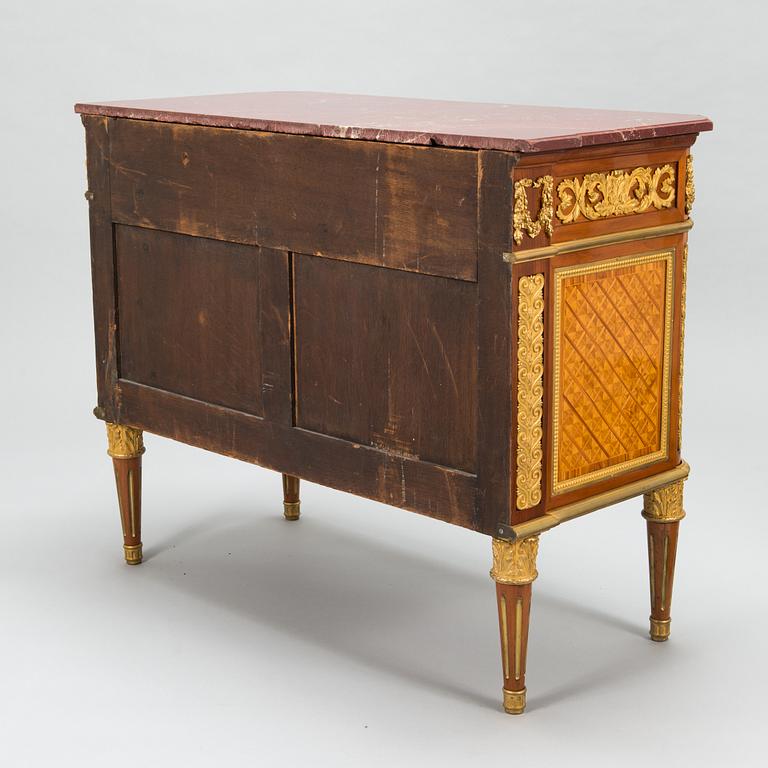 A French chest of drawer in Louis XVI style after Jean-Francois Leleu's school, late 19th century.