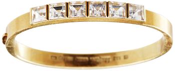 A Wiwen Nilsson 18k gold bangle with facet cut beryls.