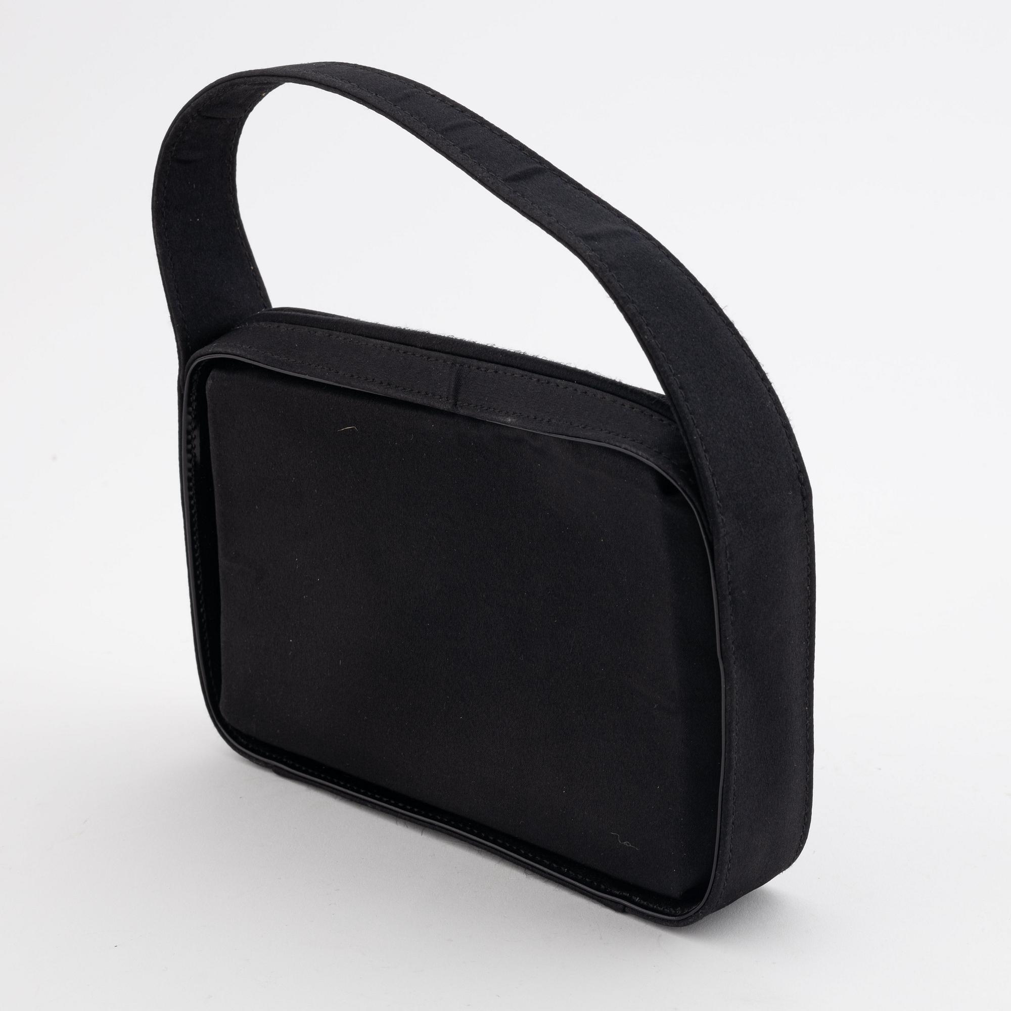 Gucci, a black satin handbag.