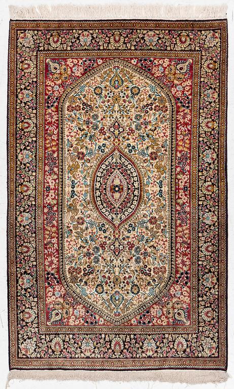 A silk Gohm rug. a 166 x 105 cm.
