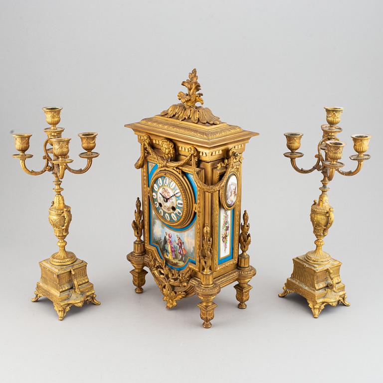 A late 19th century table clock and candelabra, probably France.